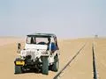White Jeep Next to Railway Tracks
