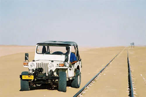 White Jeep Next to Railway Tracks