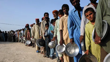 CNN Flood victims wait for food and water at a makeshift camp in Sukkur on August 23, 2010