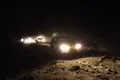 Offroading at night. The vehicles are staying within visual range of each other