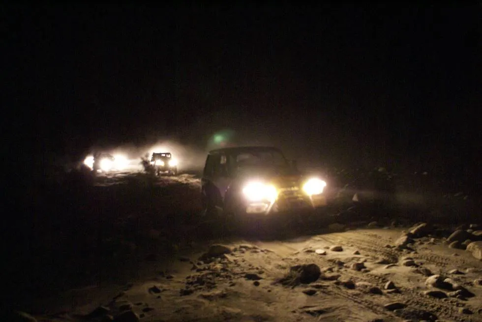 Offroading at night. The vehicles are staying within visual range of each other