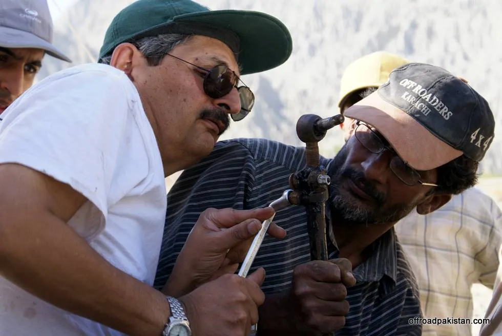 Hamid Omar guides the mechanic on how repairs are really done.